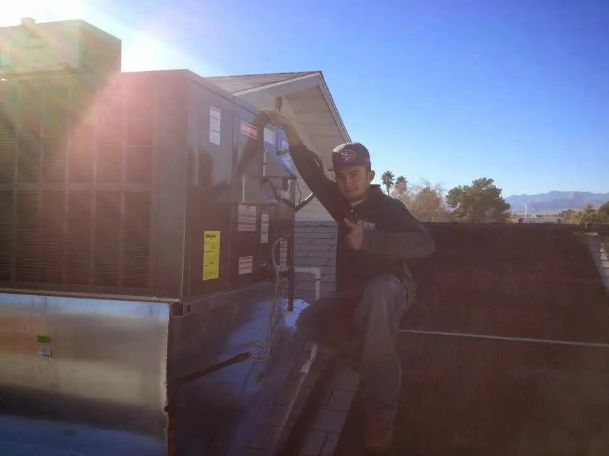HVAC technician performing AC Tune-Up on a rooftop unit in Skidaway Island